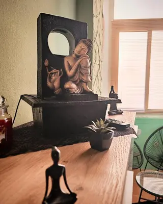 a statue of a man sitting on a table with a mirror at Guest House Scalia in Palermo