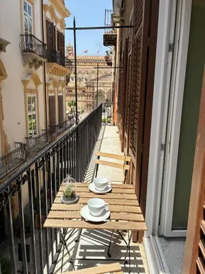 a wooden table on the balcony of a building at Vista Cattedrale - City Center in Palermo