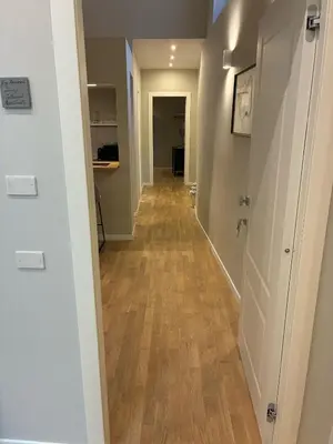 a hallway of an apartment with wooden floors at Vista Cattedrale - City Center in Palermo