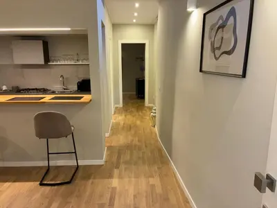a hallway with a kitchen and a chair in a room at Vista Cattedrale - City Center in Palermo