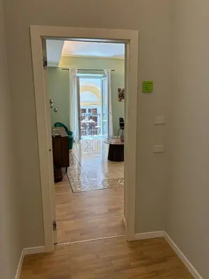 a hallway with a door leading to a living room at Vista Cattedrale - City Center in Palermo