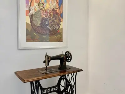 a sewing machine on a table in front of a painting at Dimora Sant'Agostino 2 in Palermo