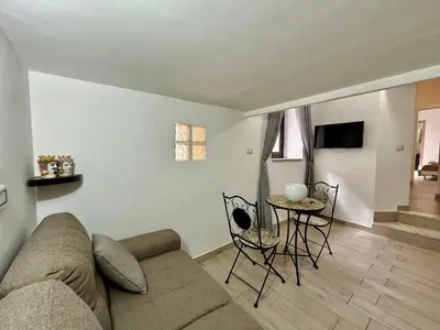 a living room with a couch and a table at Dimora Sant'Agostino 2 in Palermo