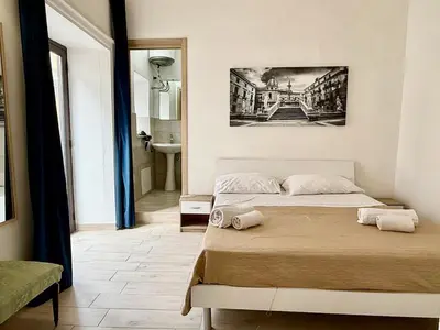 a bedroom with a bed and a bathroom at Dimora Sant'Agostino 2 in Palermo