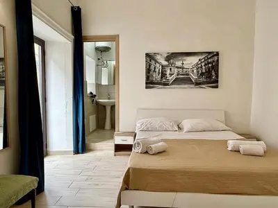 a bedroom with a bed and a bathroom at Dimora Sant'Agostino 2 in Palermo