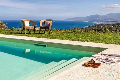 two chairs sitting next to a swimming pool at Verosicily Villa Pomelia in Termini Imerese