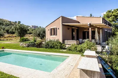 a house with a swimming pool in front of a house at Verosicily Villa Pomelia in Termini Imerese