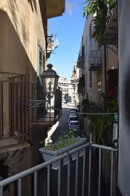 an alley with a street light and a lamp on a building at Carlita's Home in centro storico a Palermo in Palermo
