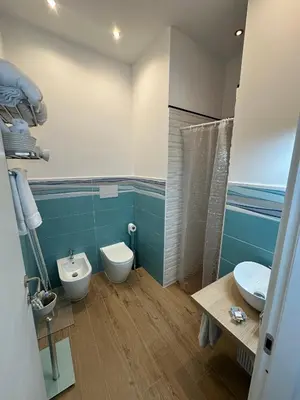 a bathroom with a toilet and a sink and a shower at Isole Siciliane Appartamento in Palermo