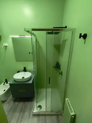 a bathroom with a glass shower and a sink at Central Apartment Cavour in Palermo
