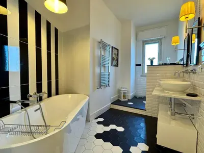 a large bathroom with a tub and a sink at Casa Parlatore in Palermo