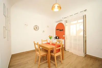 a dining room with a wooden table and chairs at La Dimora di Guglielmo Tourist Rental in Palermo