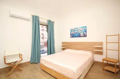 a bedroom with a bed and a window at La Dimora di Guglielmo Tourist Rental in Palermo