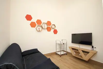 a living room with a couch and a flat screen tv at La Dimora di Guglielmo Tourist Rental in Palermo