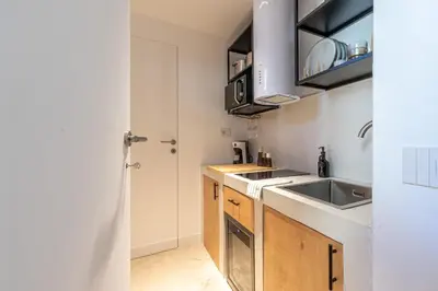 a small kitchen with a sink and a counter at Meraki Home - Alle Spalle del Teatro Massimo in Palermo