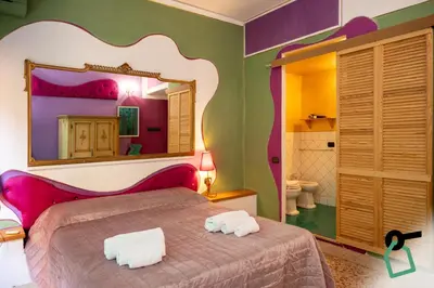 a bedroom with a bed with a large mirror at Hotiday Palermo Agostino in Palermo