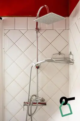 a shower shelf in a bathroom with white tiles at Hotiday Palermo Agostino in Palermo