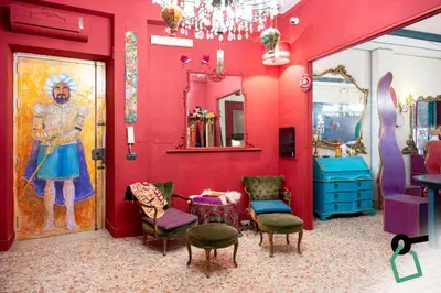 a room with a red wall with a painting on the wall at Hotiday Palermo Agostino in Palermo