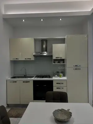 a kitchen with white cabinets and a stove top oven at Piazza Mameli Suite, comfort & elegance in Palermo in Palermo