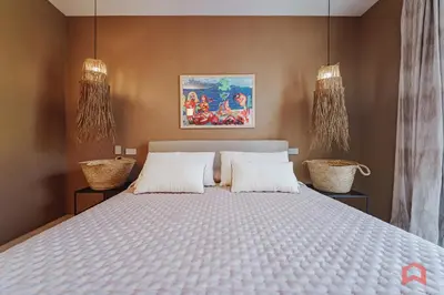 a bedroom with a large bed with two pillows at Strepitosa Villa Vista Mare con Piscina Privata in Terrasini