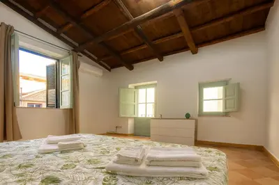 a bedroom with a bed with towels on it at Cattedrale - Vicolo Brugnò in Palermo