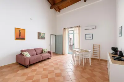 a living room with a couch and a table at Cattedrale - Vicolo Brugnò in Palermo