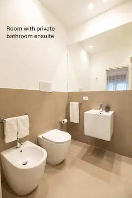 a bathroom with a toilet and a sink at Accordi al Politeama in Palermo