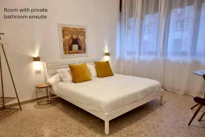 a bedroom with a white bed with yellow pillows at Accordi al Politeama in Palermo