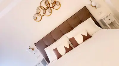 a bedroom with a bed with a wooden headboard at Ughetti Apartment in Palermo