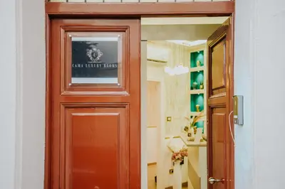 a wooden door with a sign on it at Cama Luxury Rooms in Palermo