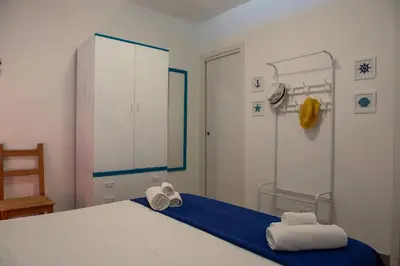 a bedroom with a bed with towels on it at CasaMare Addaura - Your Romantic Seafront Hideaway in Palermo
