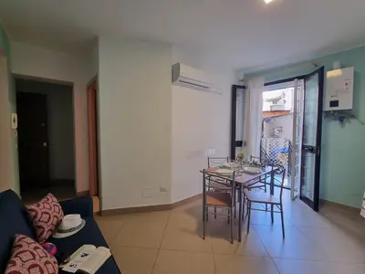 a living room with a table and a couch at Pruni's Home by Holiday World in Palermo