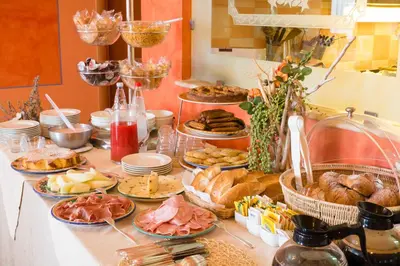 a buffet with many different types of food on a table at Hotel Villa Mare in Altavilla Milicia