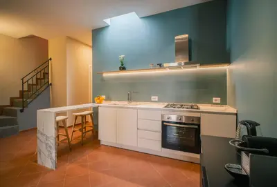 a kitchen with a sink and a stove top oven at LeSicilien - Fior di Sicilia - Apartment with Terrace in Palermo