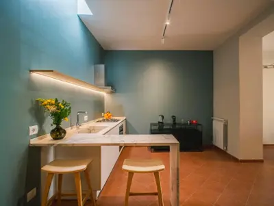 a kitchen with a counter with two stools and a sink at LeSicilien - Fior di Sicilia - Apartment with Terrace in Palermo