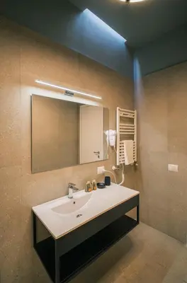 a bathroom with a sink and a mirror at LeSicilien - Fior di Sicilia - Apartment with Terrace in Palermo
