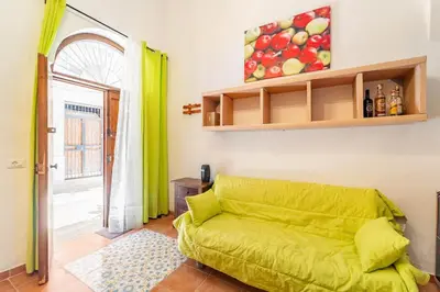 a living room with a yellow couch in a room at La petite Bastet in Palermo