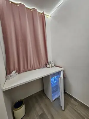 a white bedroom with a white bed and white curtains at TraMondi in Palermo
