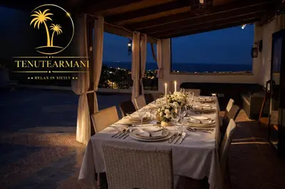 a building with a flag on top of it at Tenute Armani The Castle Live an Experience in Altavilla Milicia