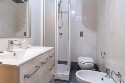 a bathroom with a toilet and a sink and a shower at 15 min to Historic Center, 5 min to Bus, Balcony in Palermo