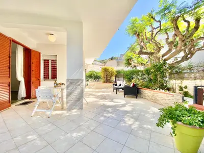 a patio of a house with flowers and lights at Villa Per Sole Mare e Relax, 200 mt dalla spiaggia in Alcamo