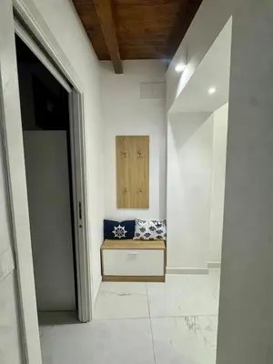 a hallway with a bench in a room at Anastasia House in Palermo