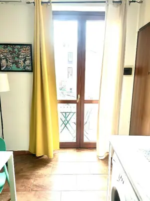 a kitchen with a sliding glass door to a patio at Via del Bosco Home in Palermo