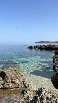 a body of water with rocks and the ocean at Casa Bambù in Macari