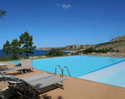 a large swimming pool with a table and chairs at Casa Bambù in Macari