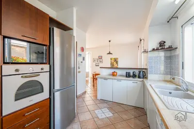 a kitchen with a stainless steel refrigerator and a sink at Villa Ametista in Alcamo