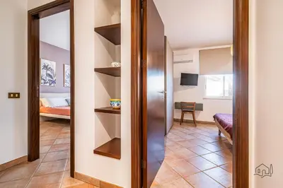a hallway with a door into a room with a bedroom at Villa Ametista in Alcamo
