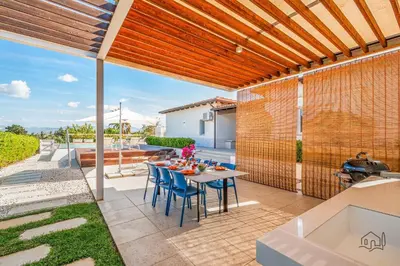 an outdoor dining area with a table and chairs at Villa Ametista in Alcamo