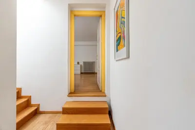 a hallway of a house with stairs and a painting at Carlo Apartment with Terrace by Wonderful Italy in Palermo