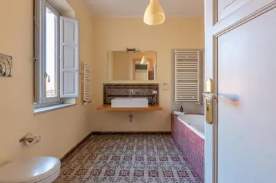 a bathroom with a tub and a toilet and a sink at Carlo Apartment with Terrace by Wonderful Italy in Palermo